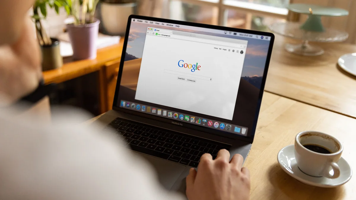 A laptop open to the Google search page on a kitchen table